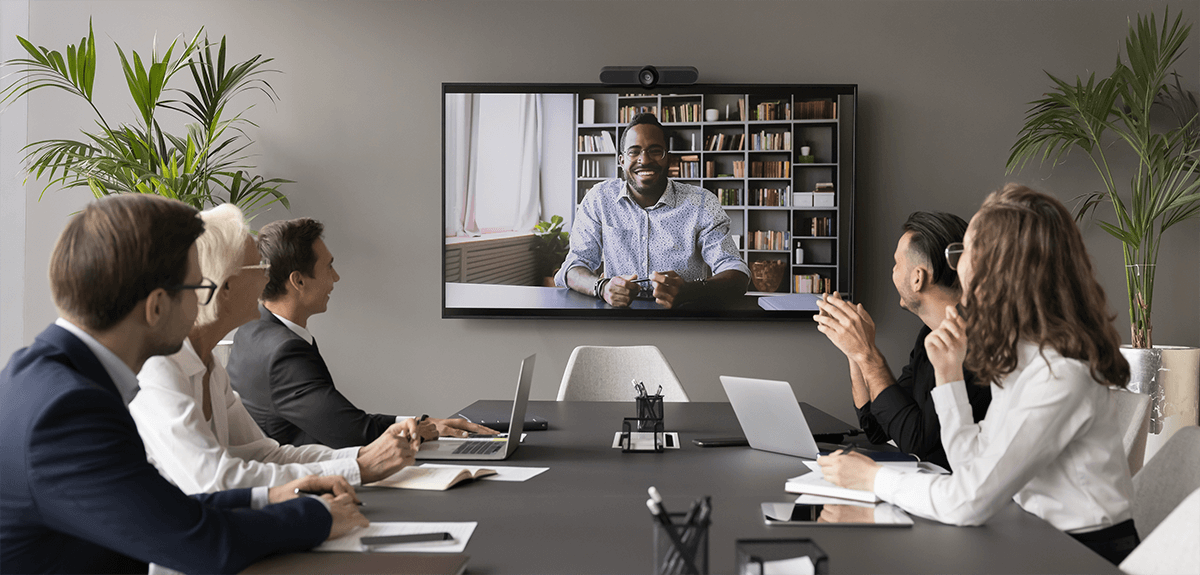 group meeting in a conference room on a video call